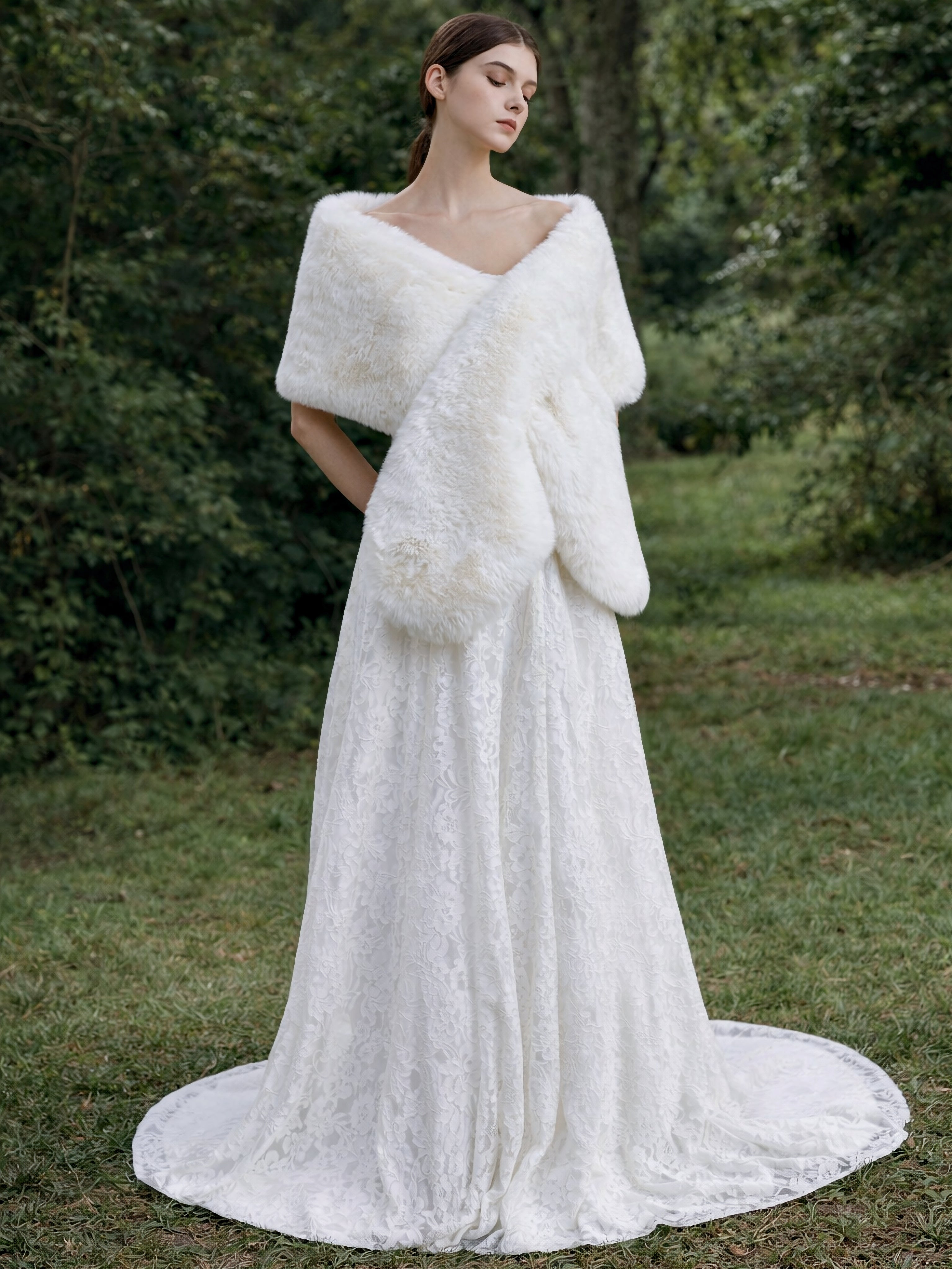 Bride wearing ivory white faux fur bridal stole at outdoor garden wedding ceremony.